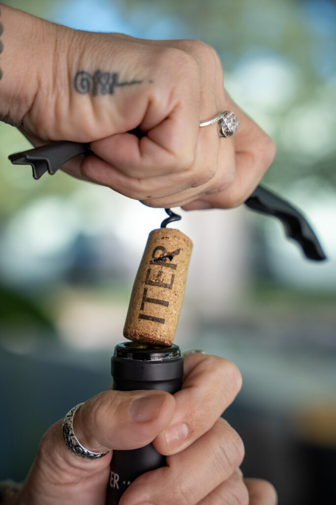Iter uncorked, corkscrew being removed from bottle