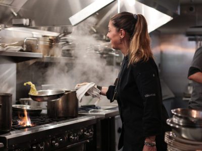 Valentina Guolo, chef cooking in restaurant kitchen